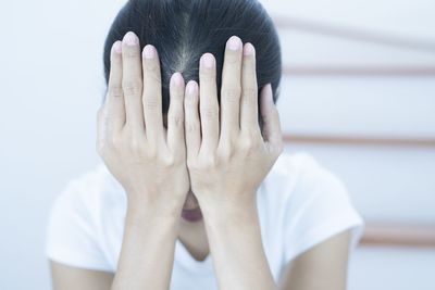 Close-up of human hand covering face