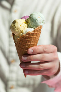 Cropped image of hand holding ice cream cone