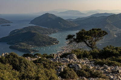 Scenic view of sea and mountains against sky