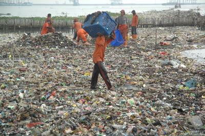 Sanitation workers cleaning garbage dump