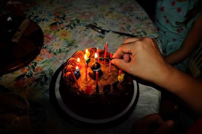 High angle view of woman holding burning candles