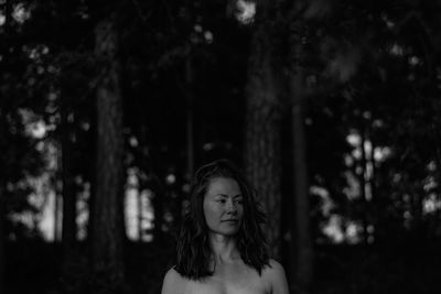 Shirtless woman at forest