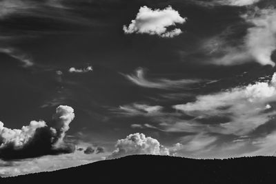 Low angle view of silhouette landscape against sky