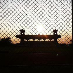 Silhouette fence at sunset