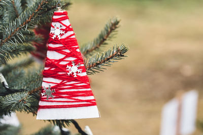 Wool and paper handmade decoration on a christmas tree outdoor. diy yarn crafts creative ideas for