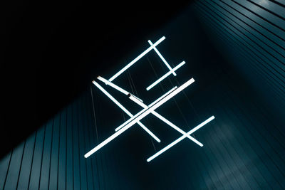 Low angle view of illuminated text on wall