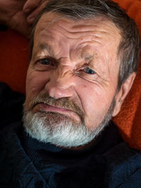 Close-up of senior man lying on bed at home