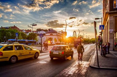 Traffic on road at sunset