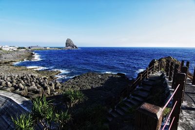 Scenic view of sea against clear blue sky