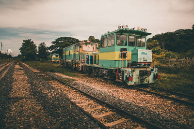 Train on railroad tracks against sky