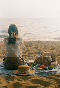 Rear view of a girl sitting on beach