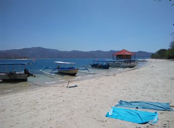 Boats in sea against clear sky