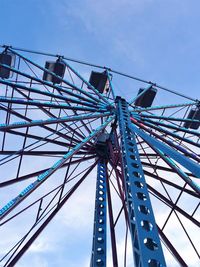 Low angle view of ferris wheel against blue sky