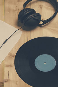 High angle view of record with headset on table