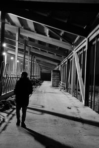 Rear view of woman walking on bridge