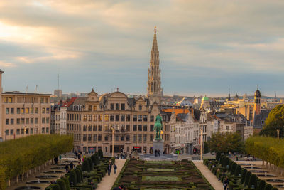 Buildings in city against cloudy sky