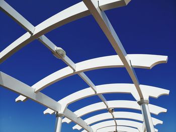 Low angle view of wood structure against clear blue sky