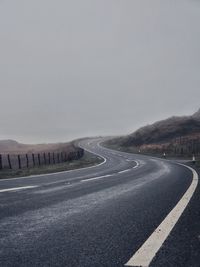 Empty road against clear sky
