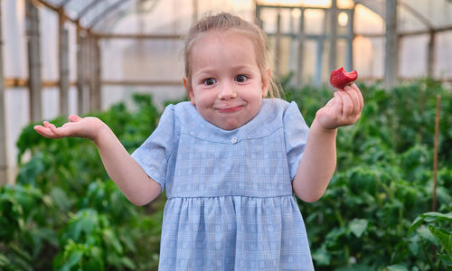 Portrait of cute girl holding apple