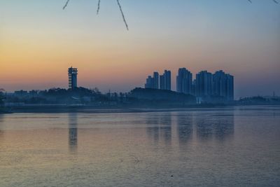 Scenic view of buildings against sky during sunrise