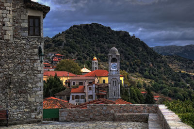 Historic building by mountains against sky
