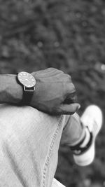 Close-up of hand holding statue against blurred background