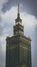 Low angle view of clock tower against sky