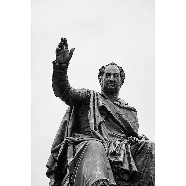 human representation, statue, sculpture, art and craft, art, creativity, low angle view, clear sky, religion, copy space, spirituality, famous place, sky, architecture, built structure, international landmark, travel destinations