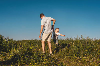 Man standing on field against clear sky