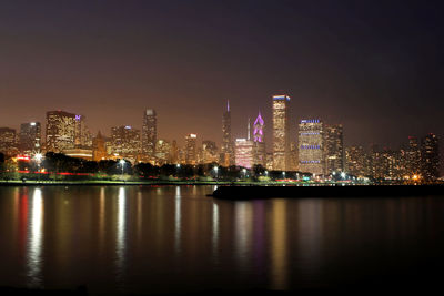 Illuminated city at waterfront