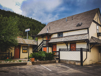 Houses by street in town against sky