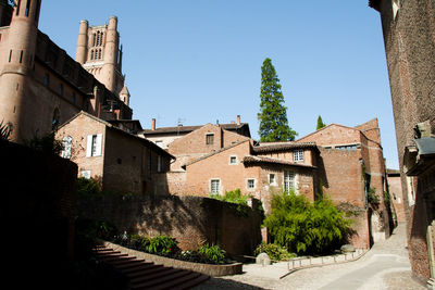 Buildings in city against clear sky