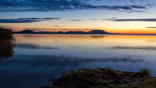 Scenic view of lake against sky during sunset