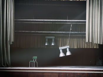 Empty chair on stage at abandoned movie theater