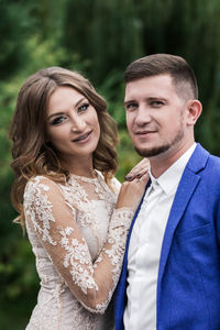 Portrait of young couple standing outdoors