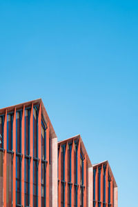 Low angle view of building against clear blue sky