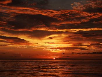 Scenic view of sea against orange sky