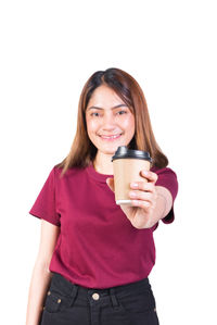 Portrait of a smiling young woman with coffee cup against white background