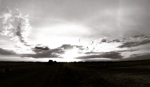 Scenic view of silhouette field against sky