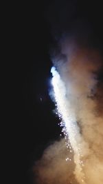 Low angle view of illuminated stage against sky at night