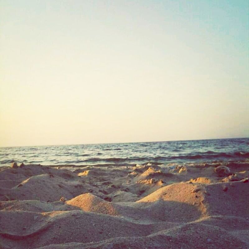 sea, horizon over water, beach, water, clear sky, copy space, scenics, tranquil scene, tranquility, shore, beauty in nature, nature, sand, idyllic, remote, wave, coastline, sky, outdoors, calm