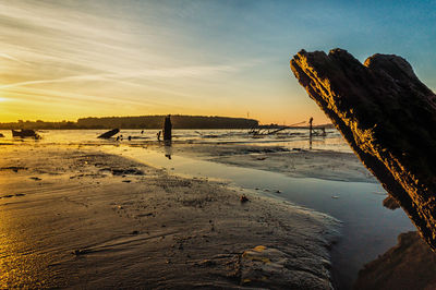 Scenic view of beach against sky during sunset