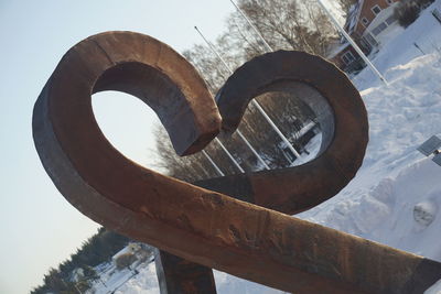 Low angle view of metal against sky