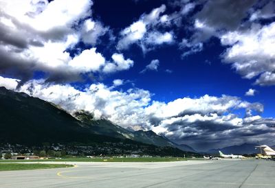 Empty road with mountains in background