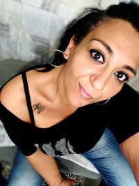 Portrait of a smiling young woman at home