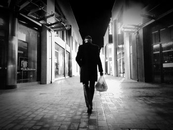 Rear view of a man walking on street