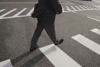 Low section of people walking on road