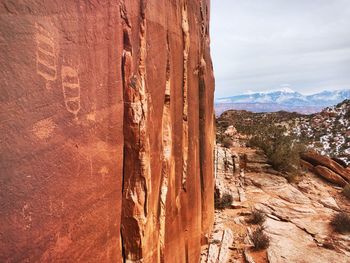 View of rock formation against cloudy sky