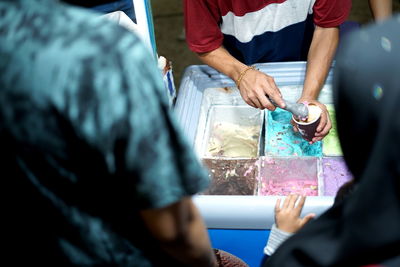 Vendor prepare colourful ice cream at street food bazaar