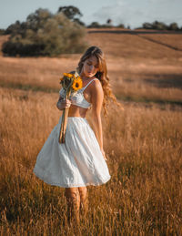 Portrait of a beautiful young woman in field